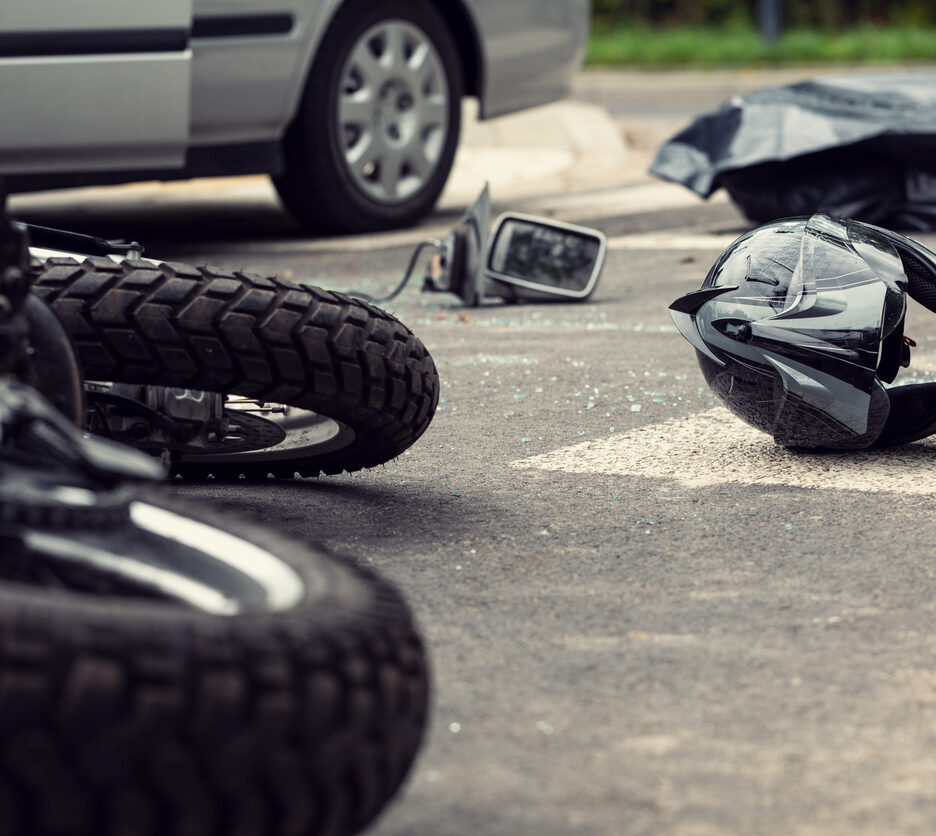 Motorcycle and helmet on the street after dangerous traffic incident