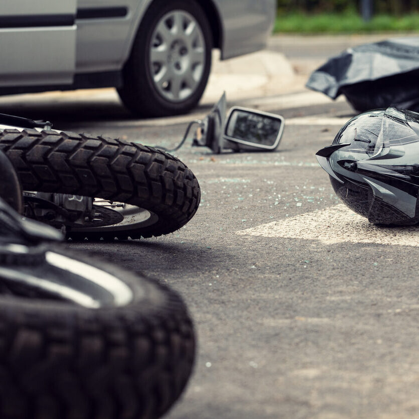 Motorcycle and helmet on the street after dangerous traffic incident