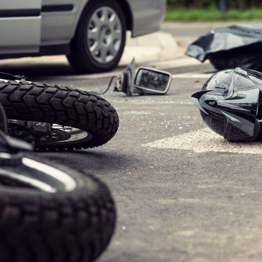 Motorcycle and helmet on the street after dangerous traffic incident