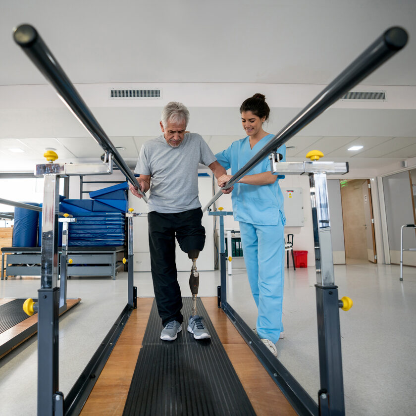 Disabled senior man wearing a prosthetic and doing physical therapy
