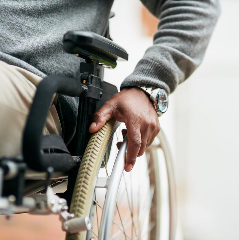 Cropped shot of a senior man sitting in his wheelchair at home