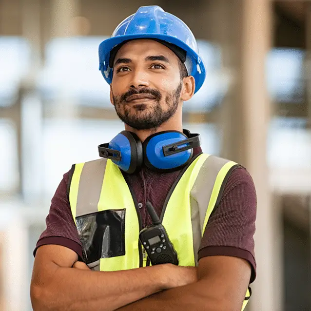 Construction worker in a hardhat looks past the camera and smiles